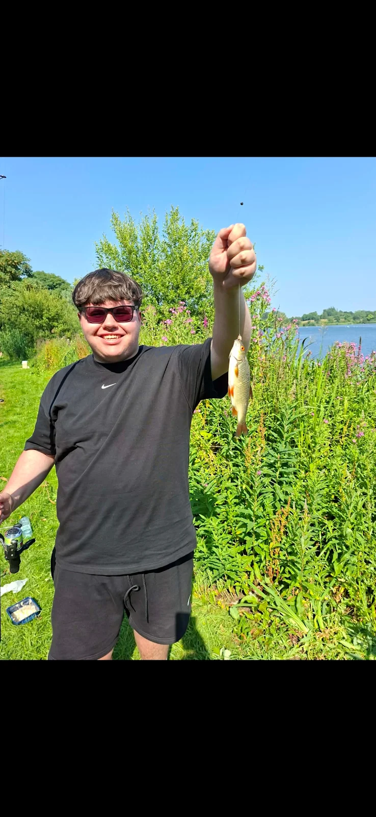 Zach Perkins with a Roach on his first ever fishing trip, catching 6 fish