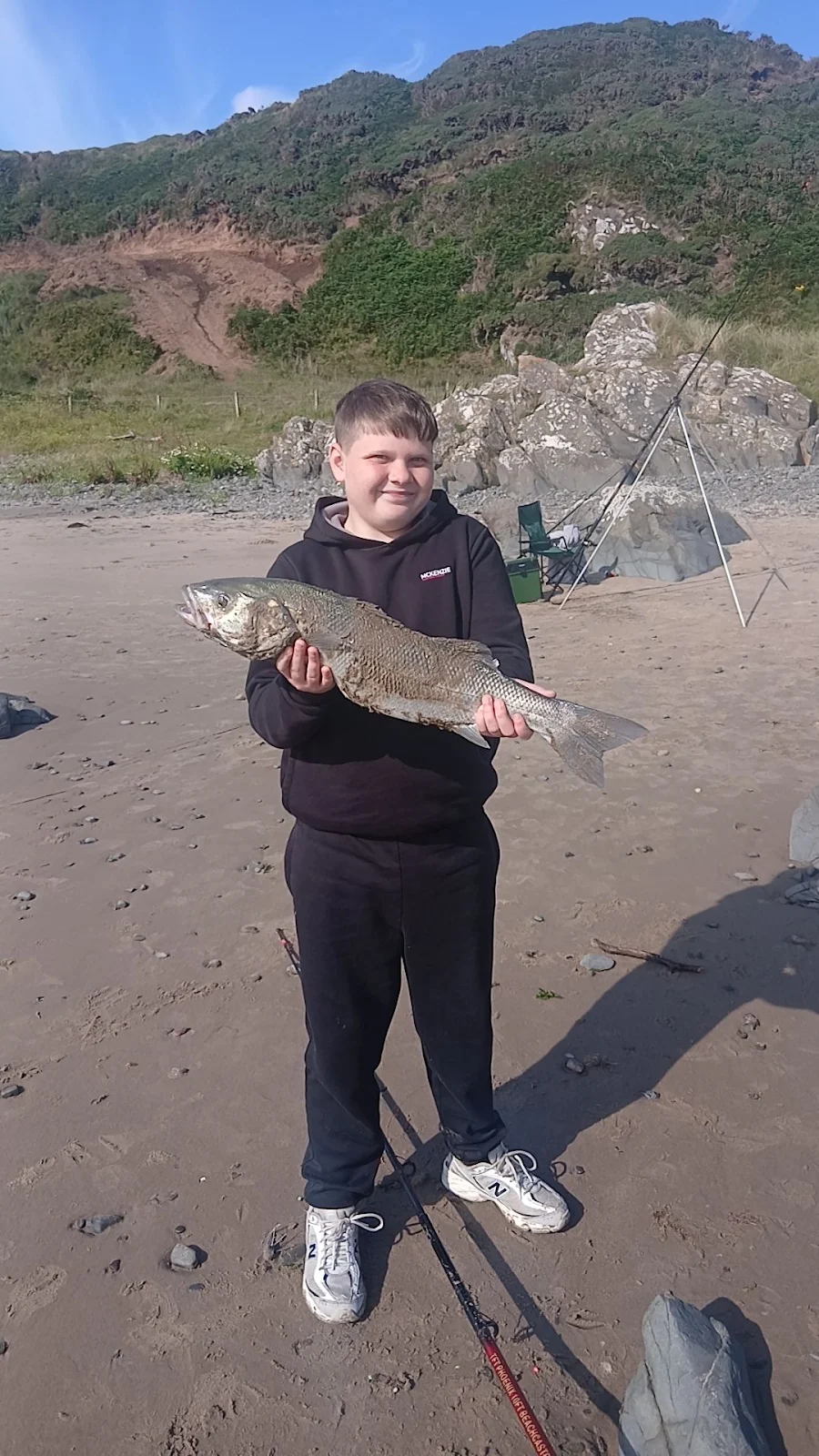William Paterson's son with a Bass caught on fresh lugworm from the shore in SW Scotland after 3 hours with no bites